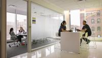 Four students working in the Columbia Nursing building.